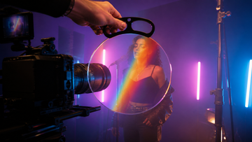 Filmmaker using a handheld prism filter during a music video portrait shoot
