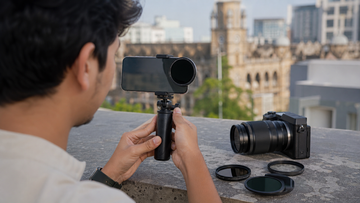 Creator filming outdoors with a phone-mounted ND filter and camera gear