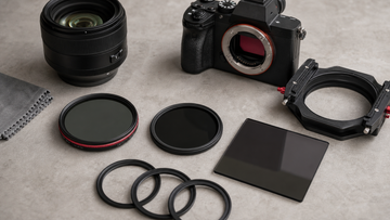 Circular ND filters, variable ND filter and square filter holder arranged beside a mirrorless camera