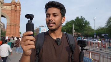 Creator filming travel vlog with pocket camera action camera and wireless microphone