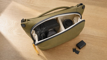 Open Peak Design Everyday Sling 6L with a mirrorless camera, a second lens and dividers inside; generated illustration