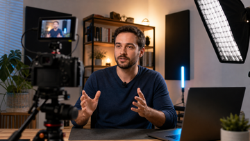 Creator recording a professional YouTube talking head video with camera light and microphone